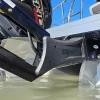Close up image of whiptail motor mount installed on a pontoon boat sitting in shallow water